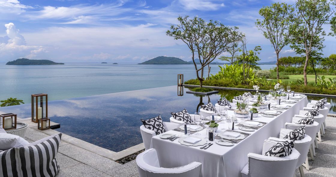A Table With Chairs And A View Of The Ocean