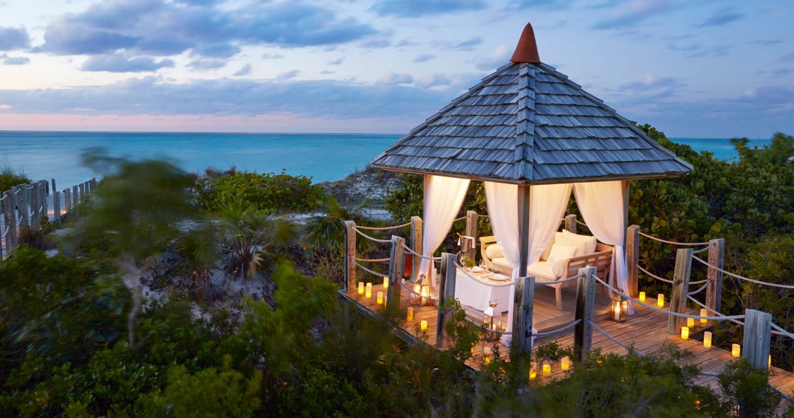 A Gazebo On A Hill Overlooking A Body Of Water