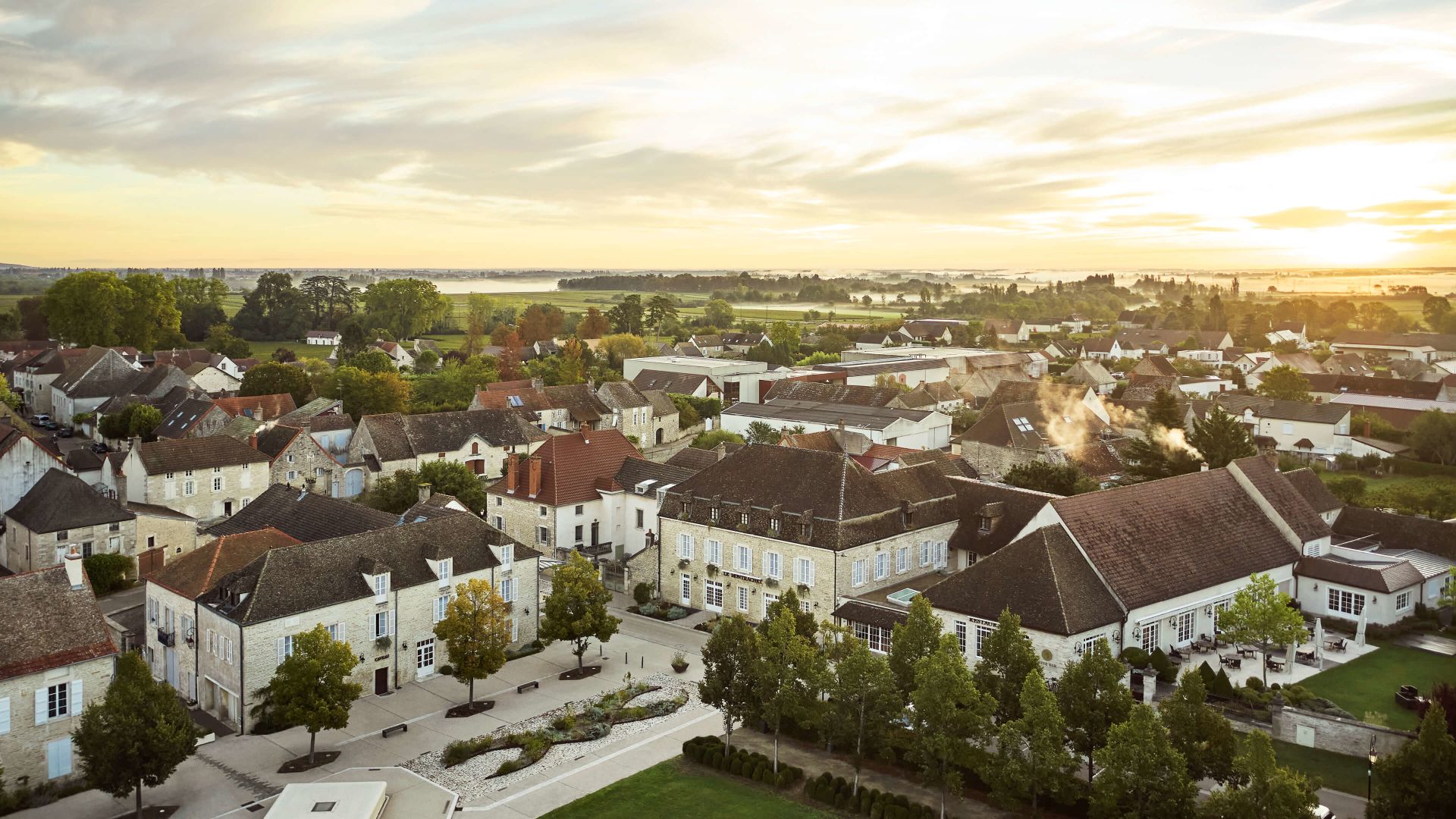 A Group Of Buildings With Trees In The Front