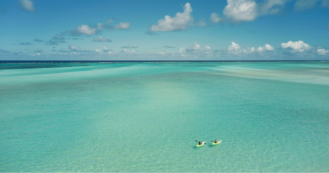 A Group Of People In A Body Of Water