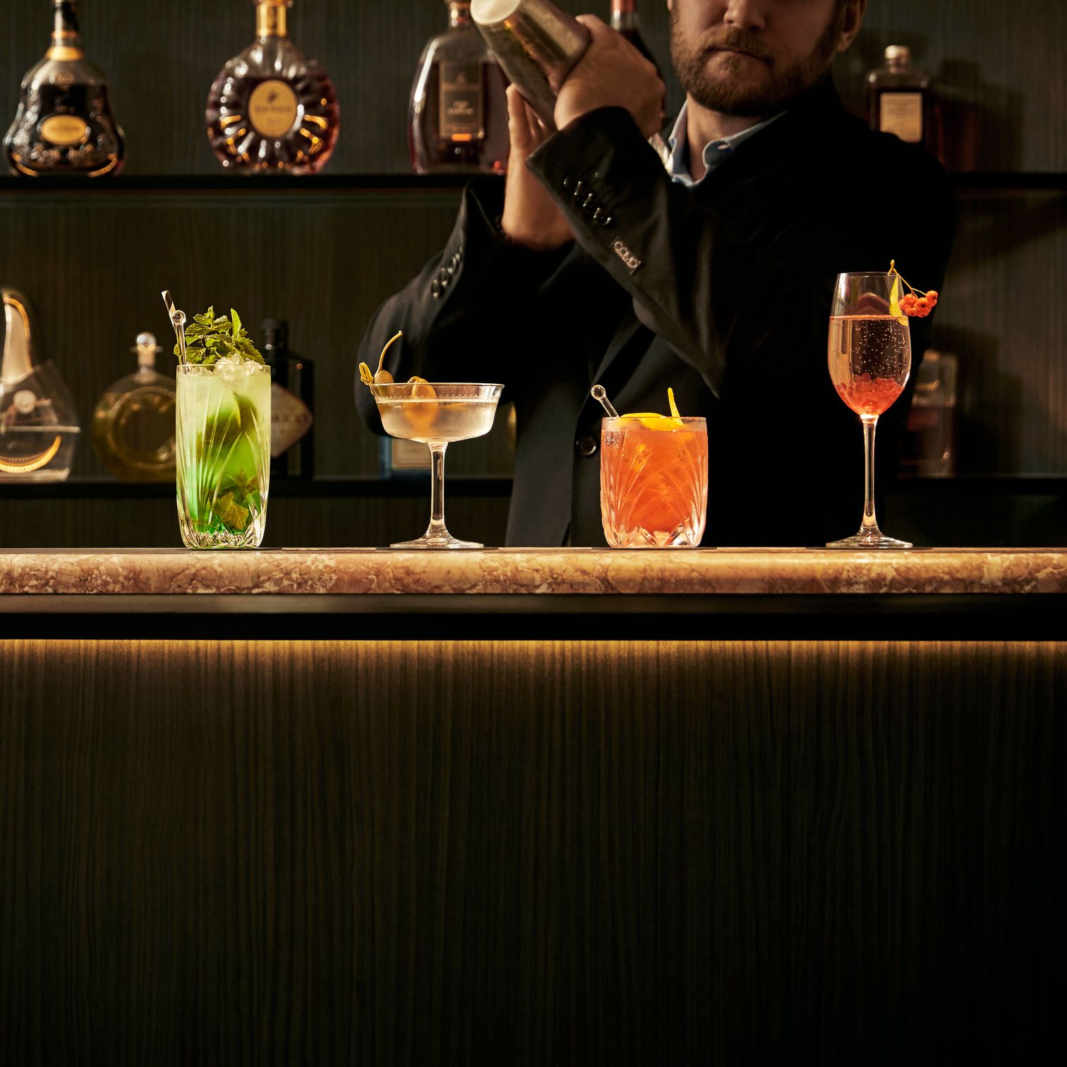 A Person Pouring A Drink Into A Glass