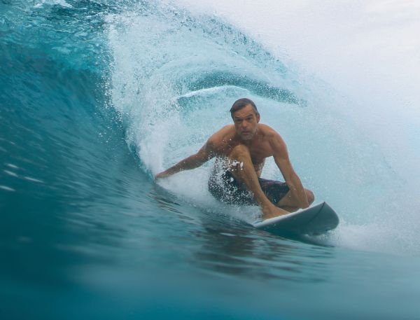 A Man Riding A Surfboard