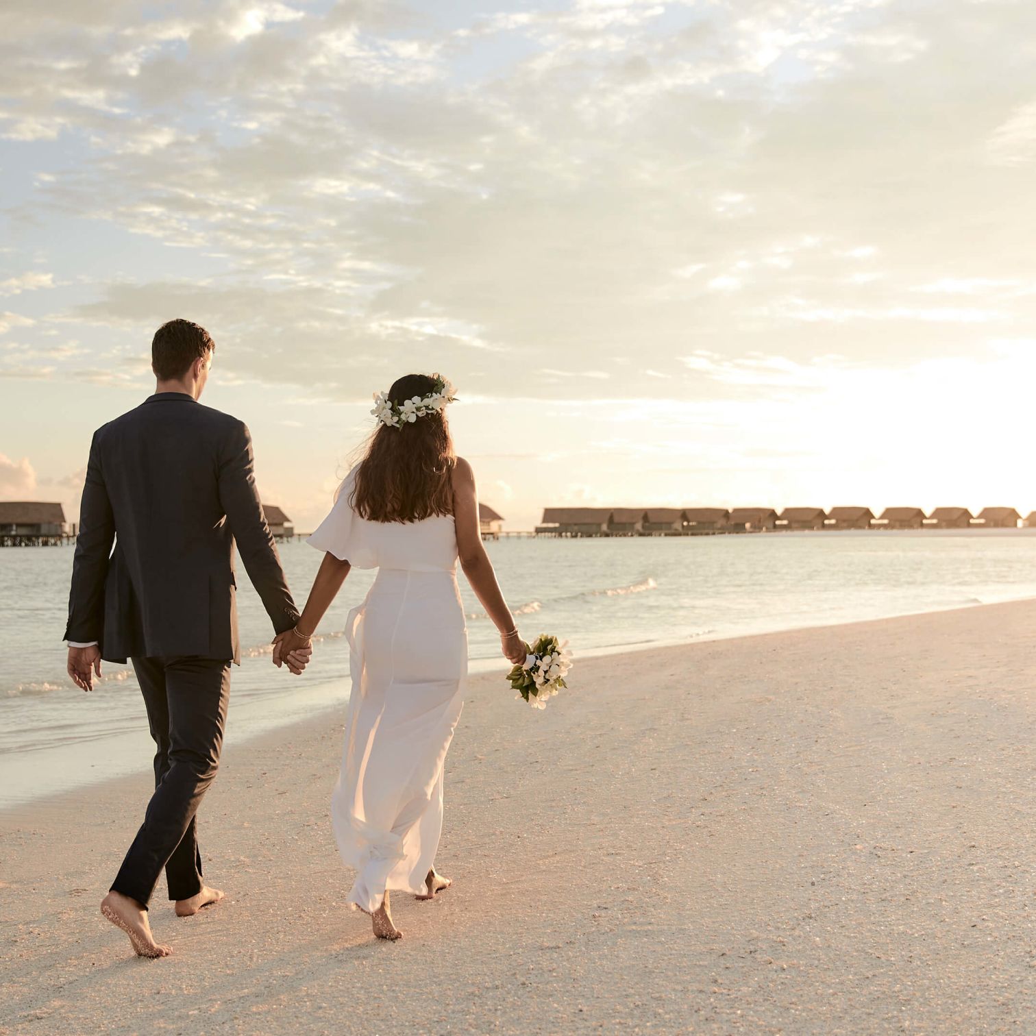 A Man And Woman Walking On A Beach