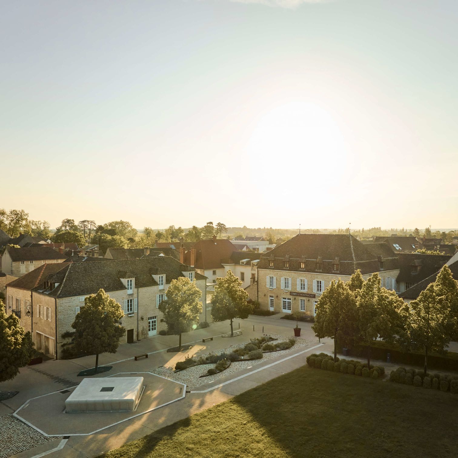 A Group Of Buildings With Trees In Front Of Them