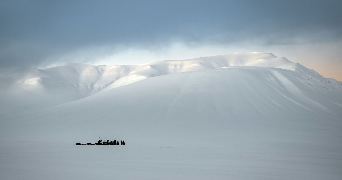 A Group Of People On A Snowy Mountain