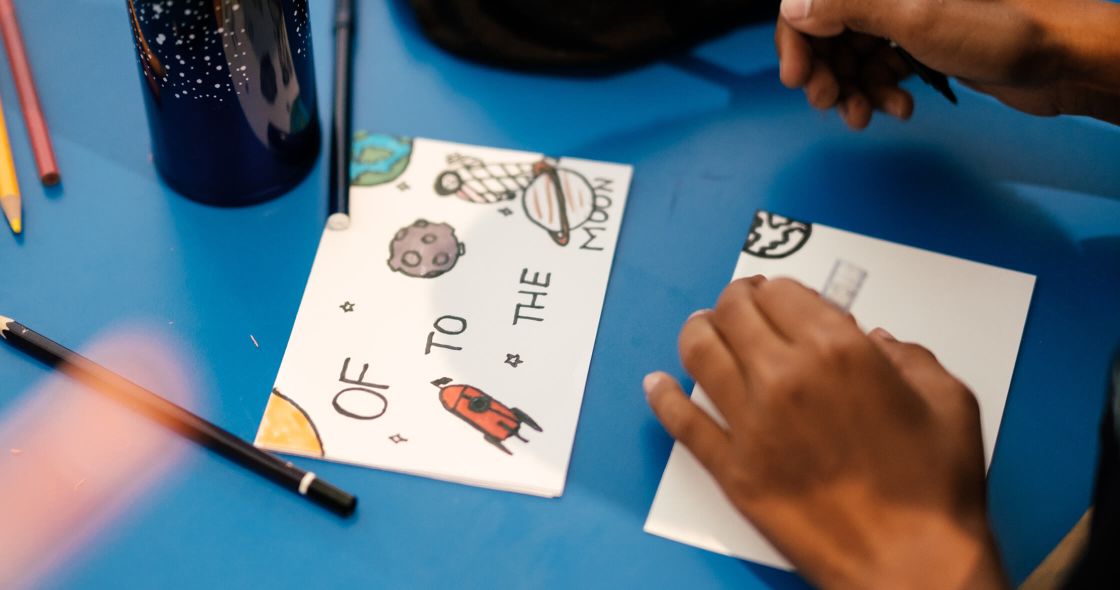 A Person Drawing On A Paper