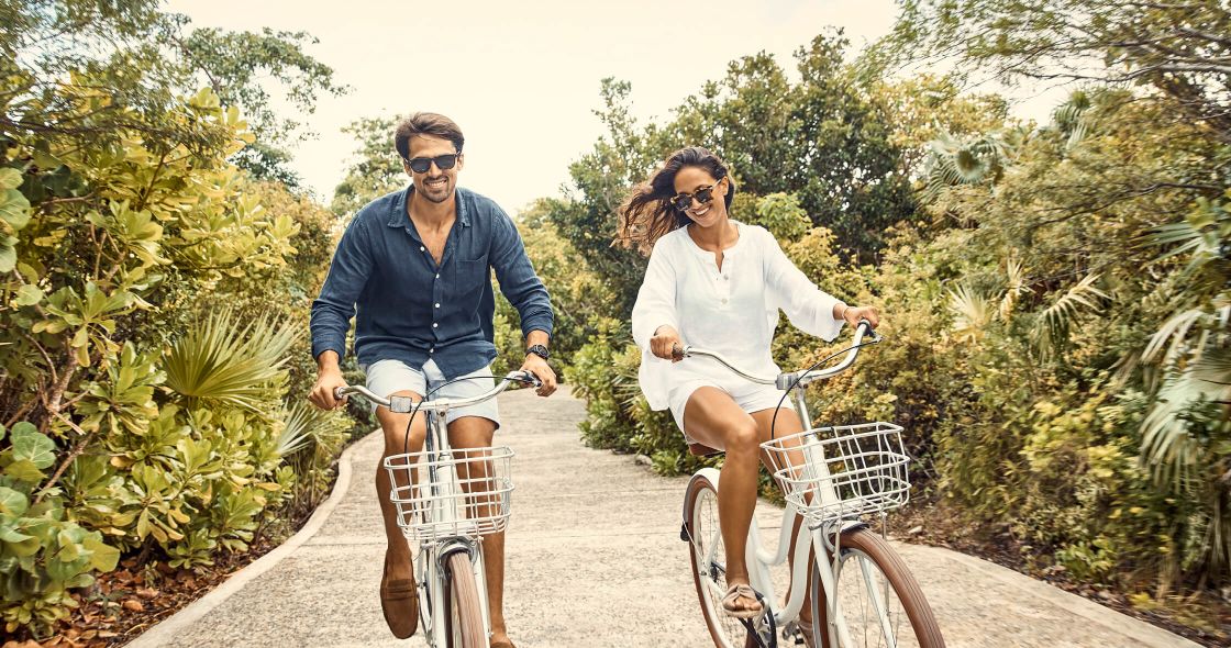 A Man And Woman Riding Bicycles