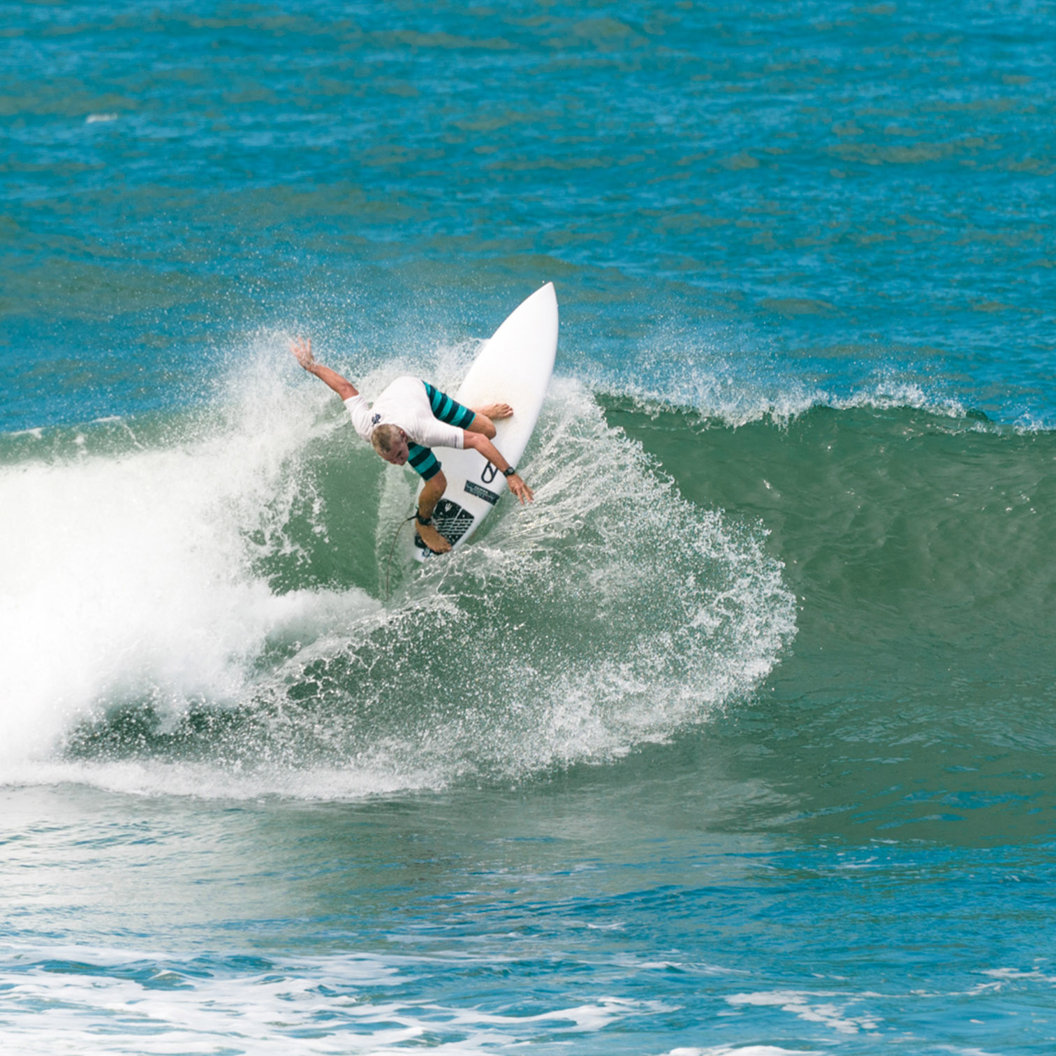 A Man Surfing On A Wave
