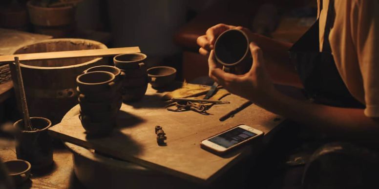 A Hand Holding A Cup Of Coffee