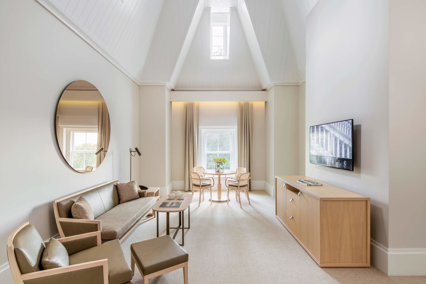 A Living Room With A Tv And Couches