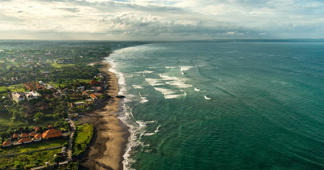 A Beach With Houses And Trees