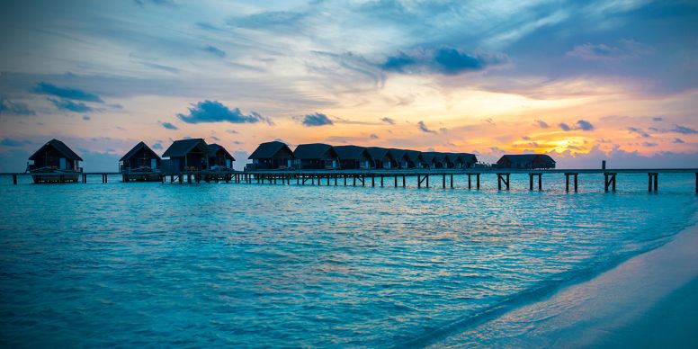 A Row Of Houses On A Beach