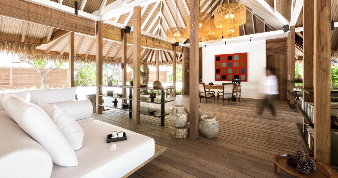 A Room With A Wood Floor And A White Couch And A Table