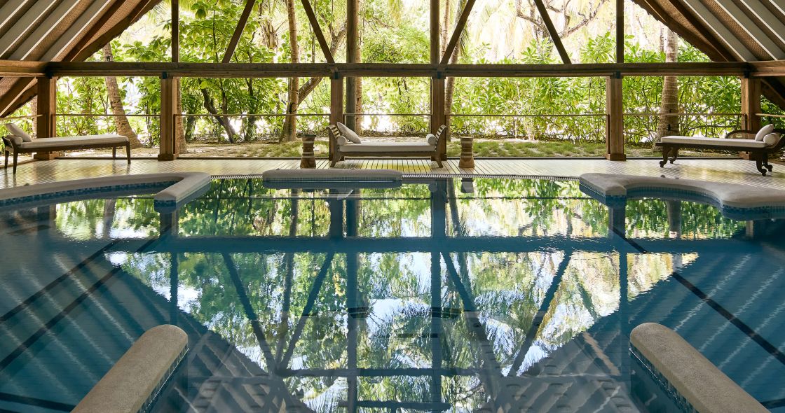 A Large Wooden Structure With A Pool