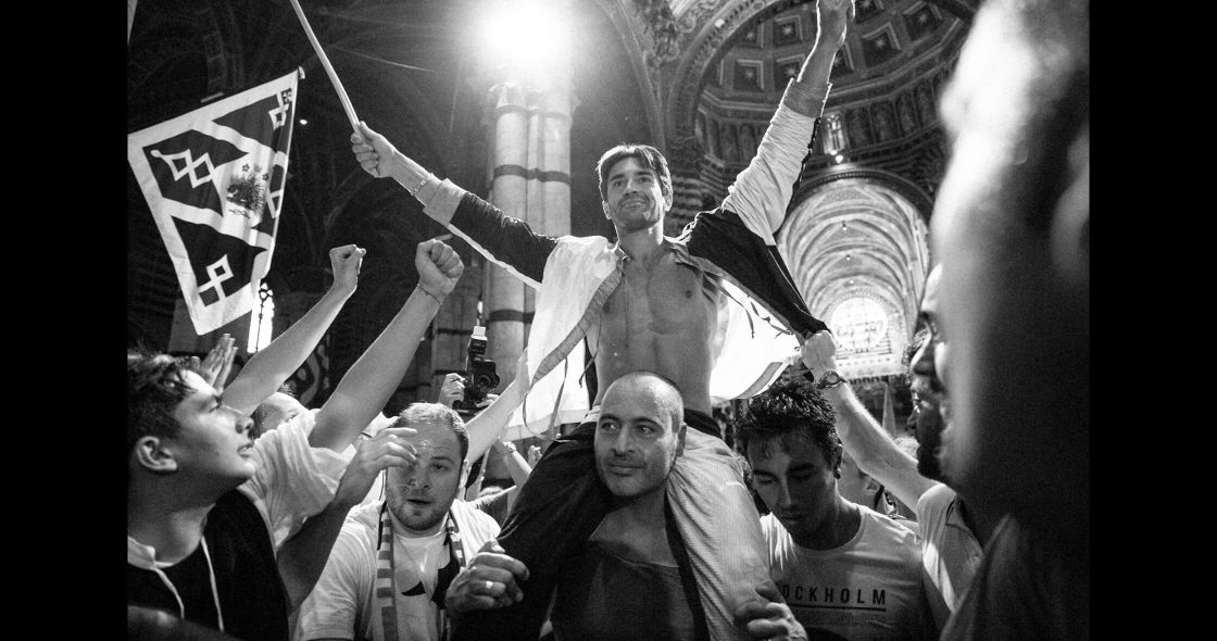 A Group Of People Holding Flags