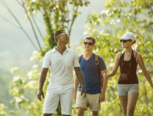 A Group Of People Walking In A Field