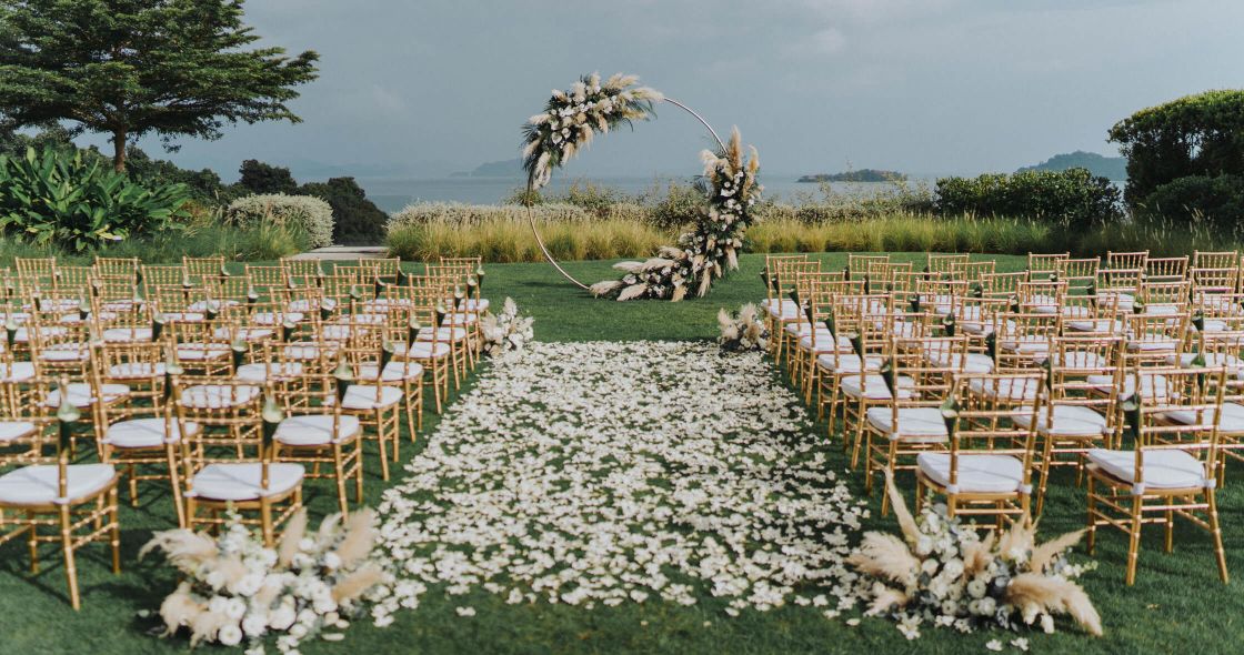 A Large Group Of Tables And Chairs In A Field
