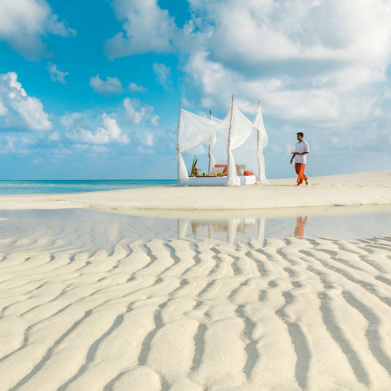 A Group Of People Riding Skis On A Beach