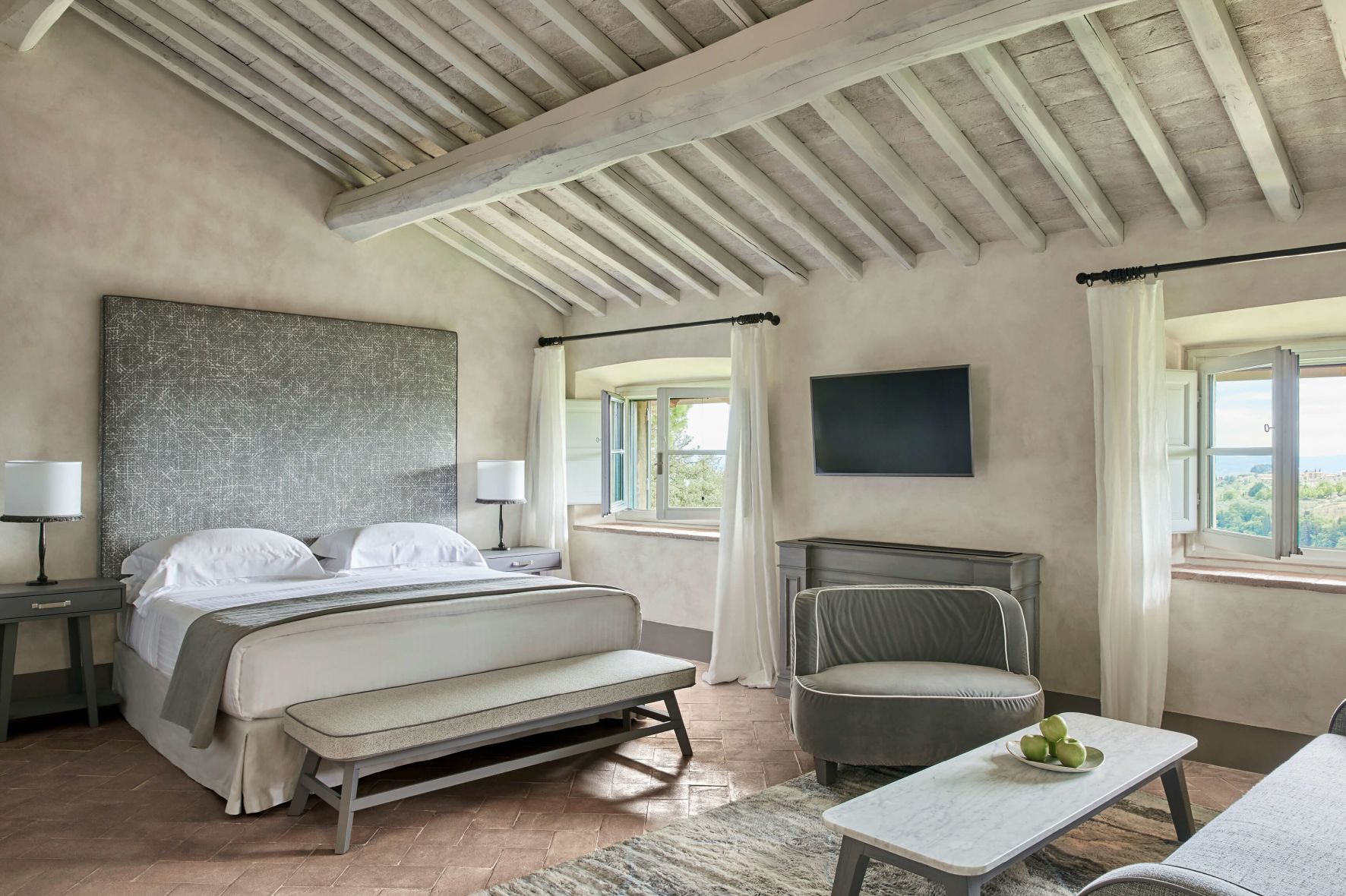 A Bedroom With A Bed And A Chair