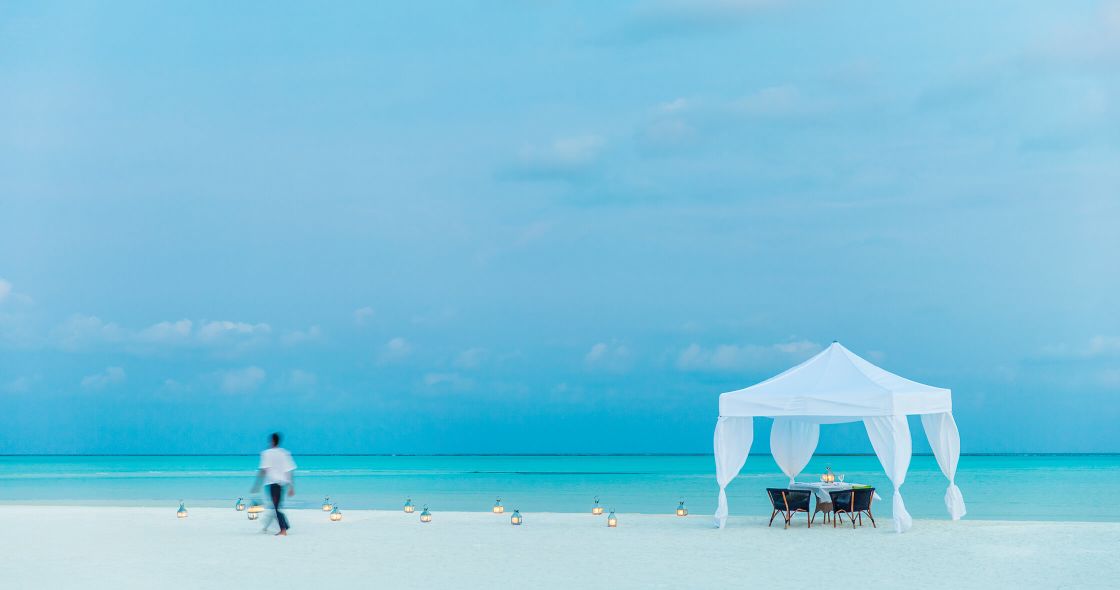 A Person Walking On A Beach