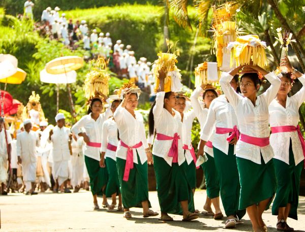 A Group Of People Wearing Hats And Holding Umbrellas