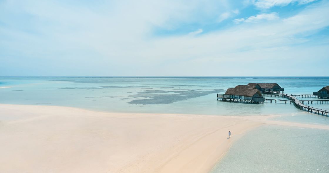 A Beach With A Pier And Buildings