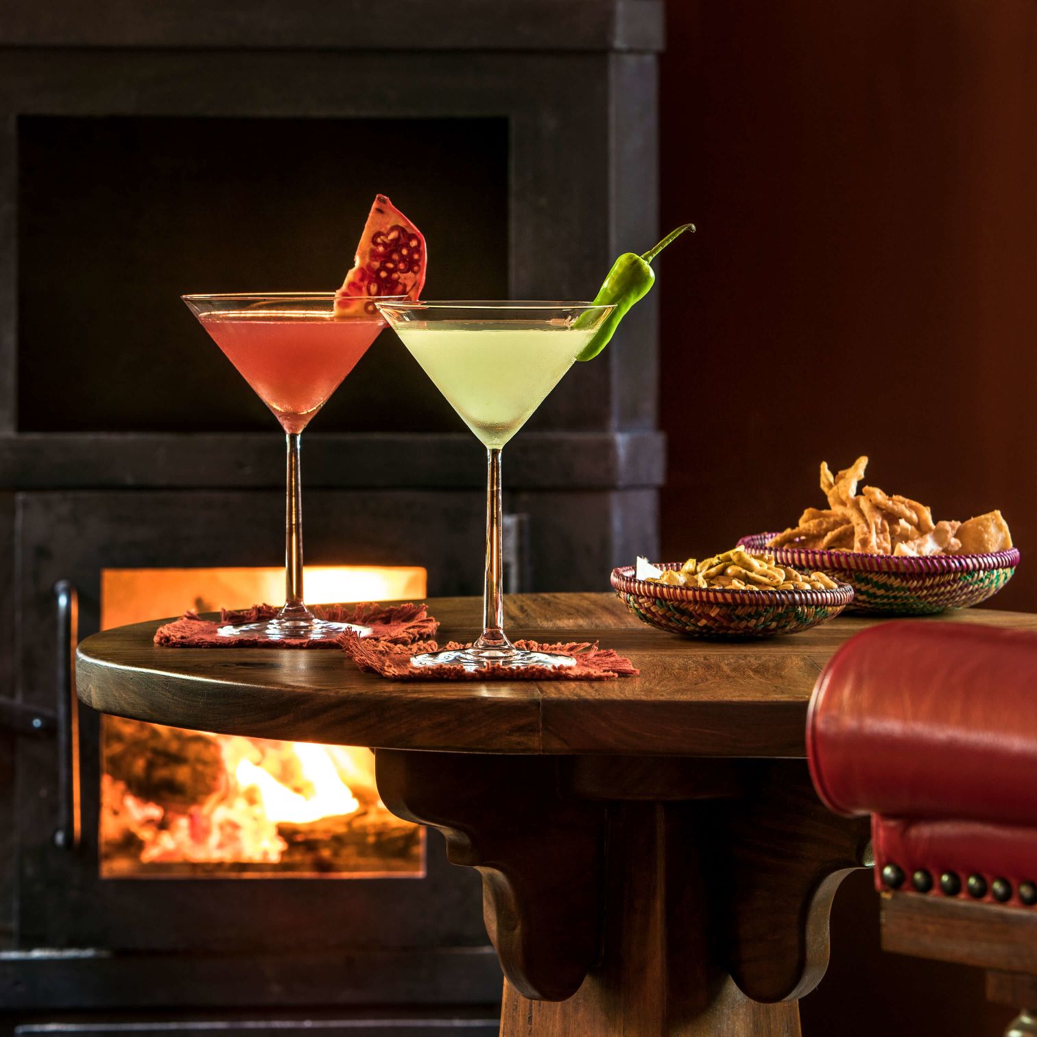 A Couple Of Glasses With Drinks In Them On A Table
