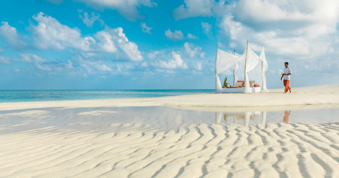 A Person Walking On A Beach