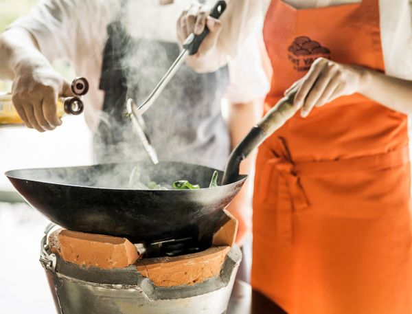 A Person Cooking Food In A Pot