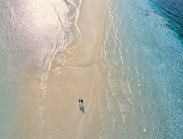 A Person Flying Through The Air While Riding A Wave