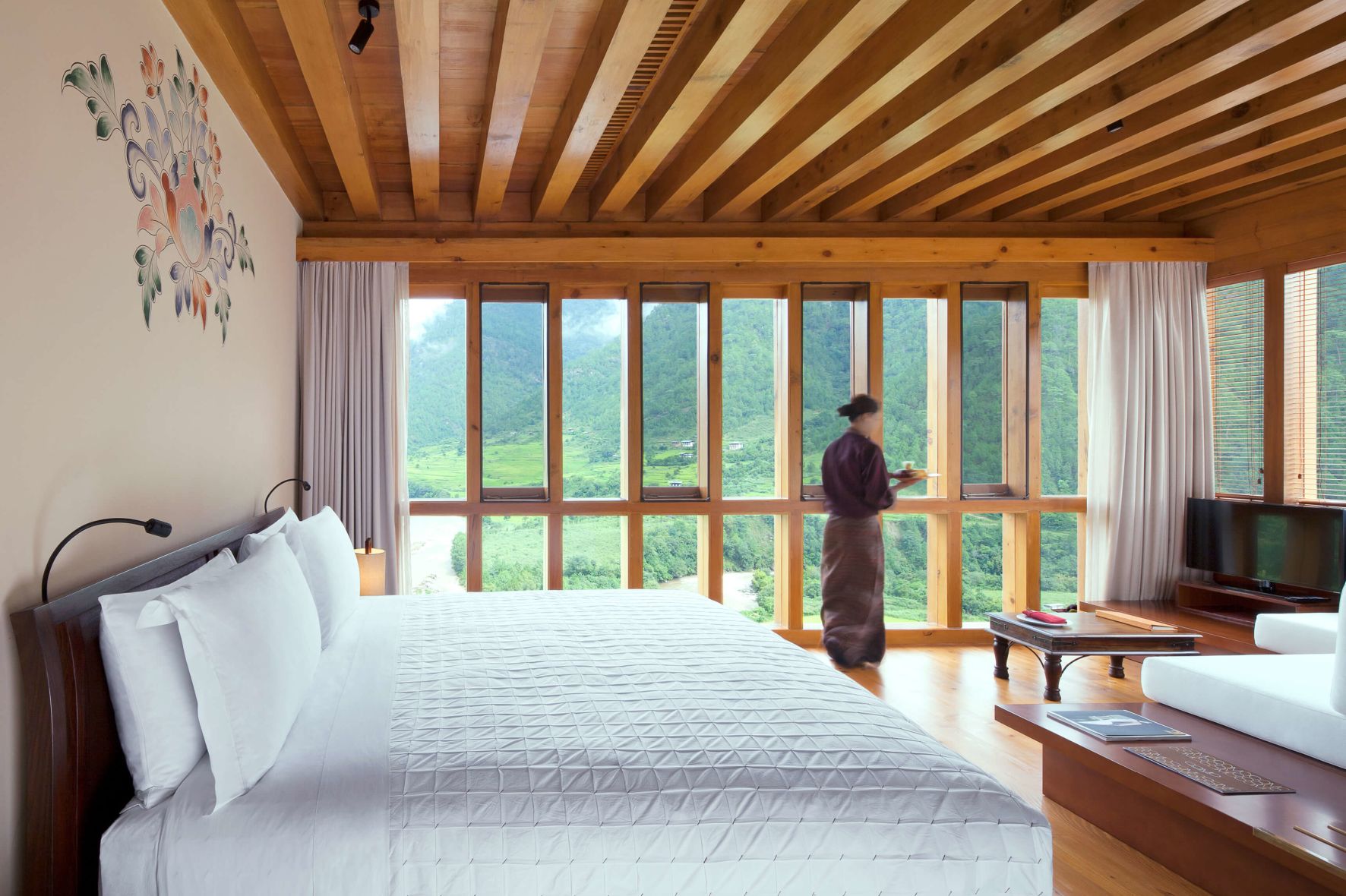 A Person Standing In A Room With A Large Window